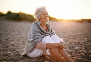 Happy woman sitting on beach